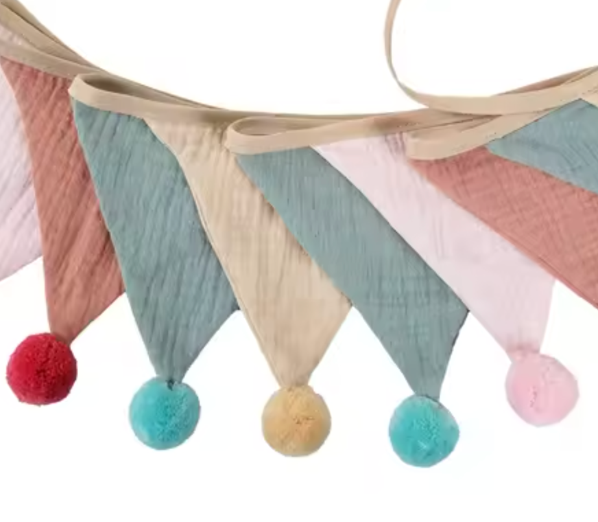 Colorful fabric banner with pom-pom ends on a white background