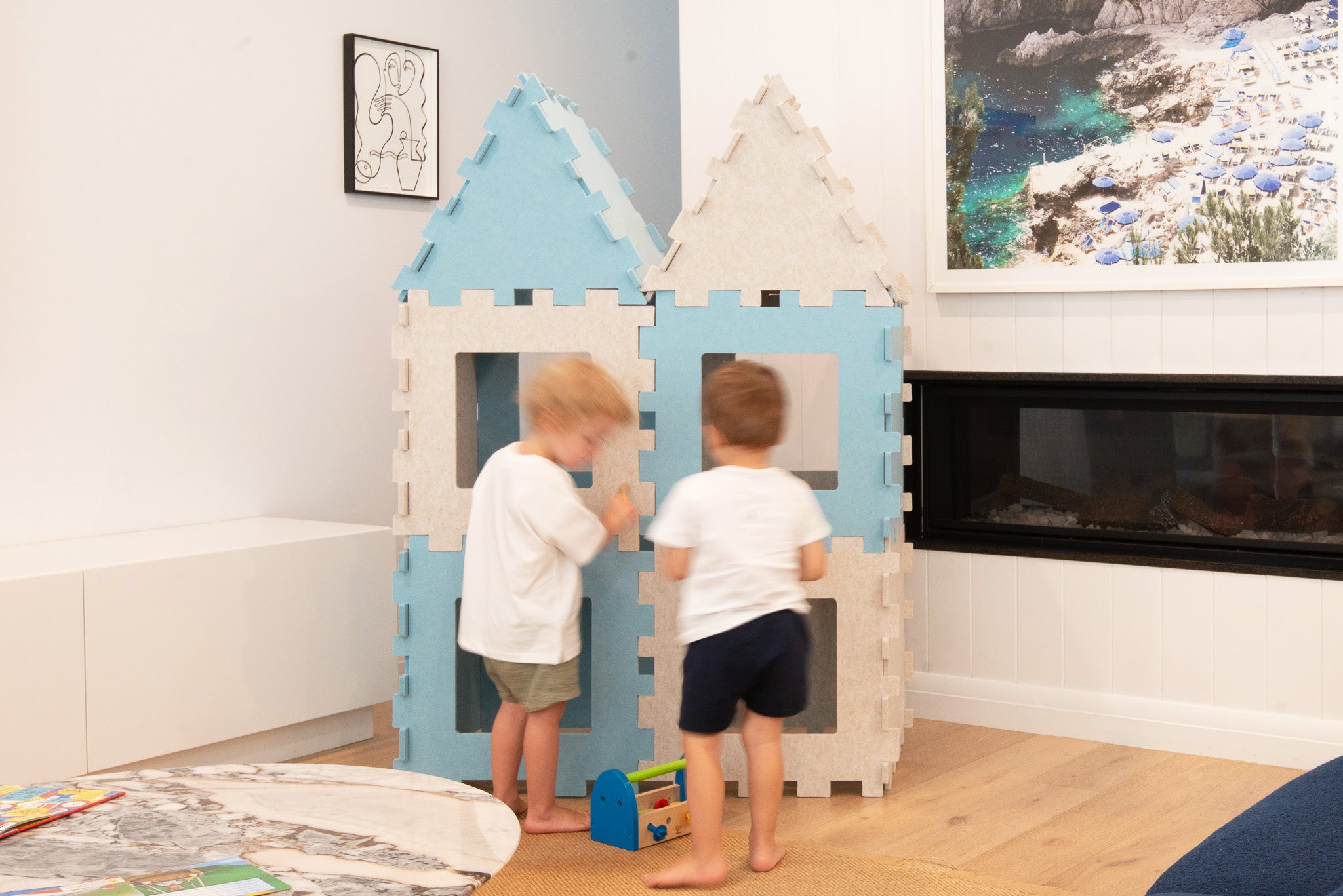Fuzzy Forts made into a little kids dream fix it garage with two boys playing with their toolbox and fixing their forts